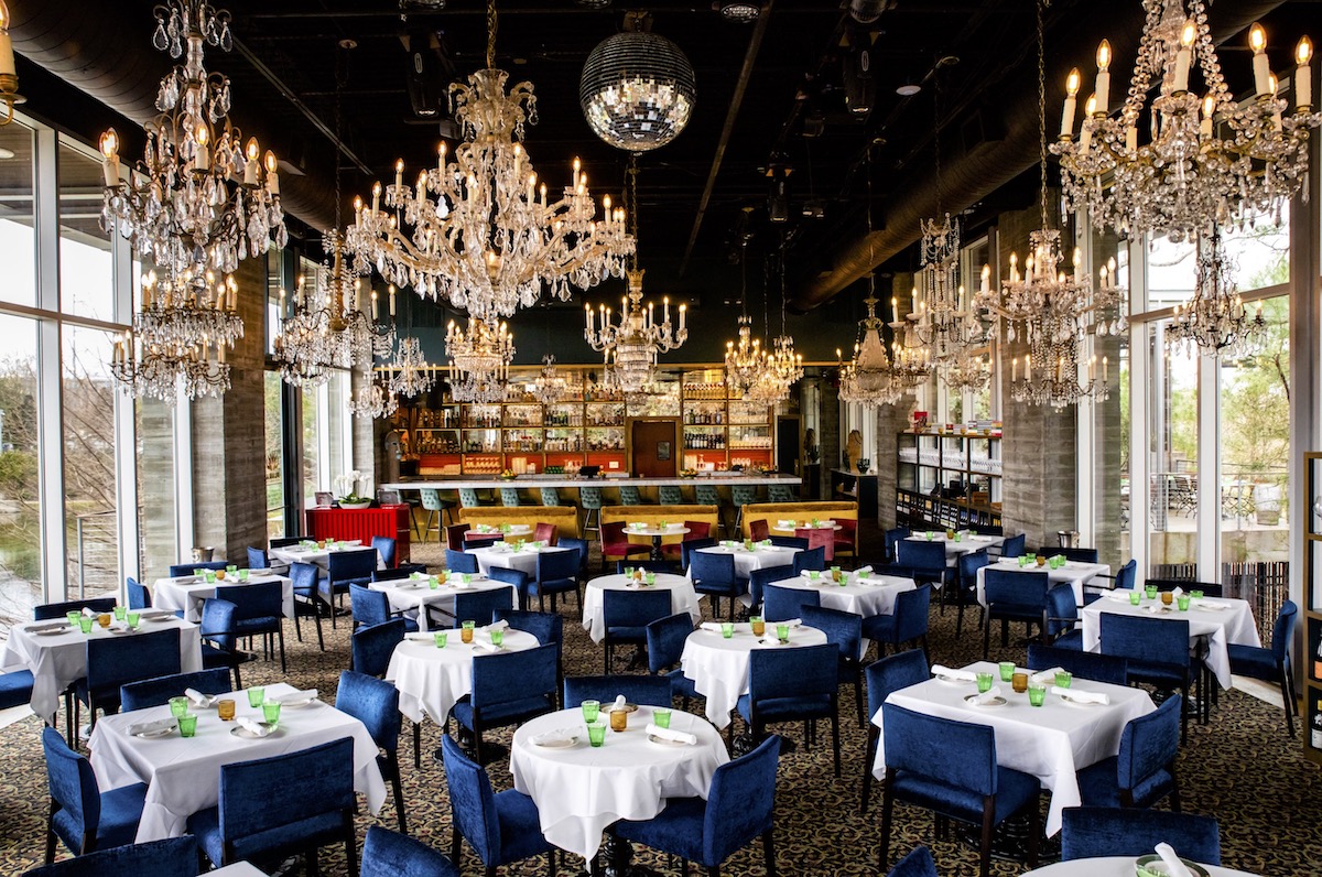 Chandeliers bedeck Flora's dining room and illuminate the treehouse-like space. | Photo by Kirsten Gilliam