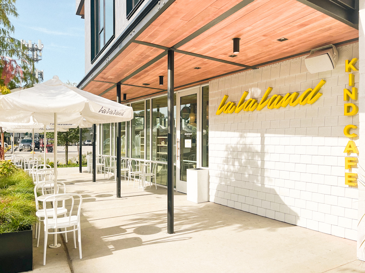 La La Kind Cafe's patio is accenteed with the brand's signature white and yellow aesthetic. | Photo by La La Kind Cafe