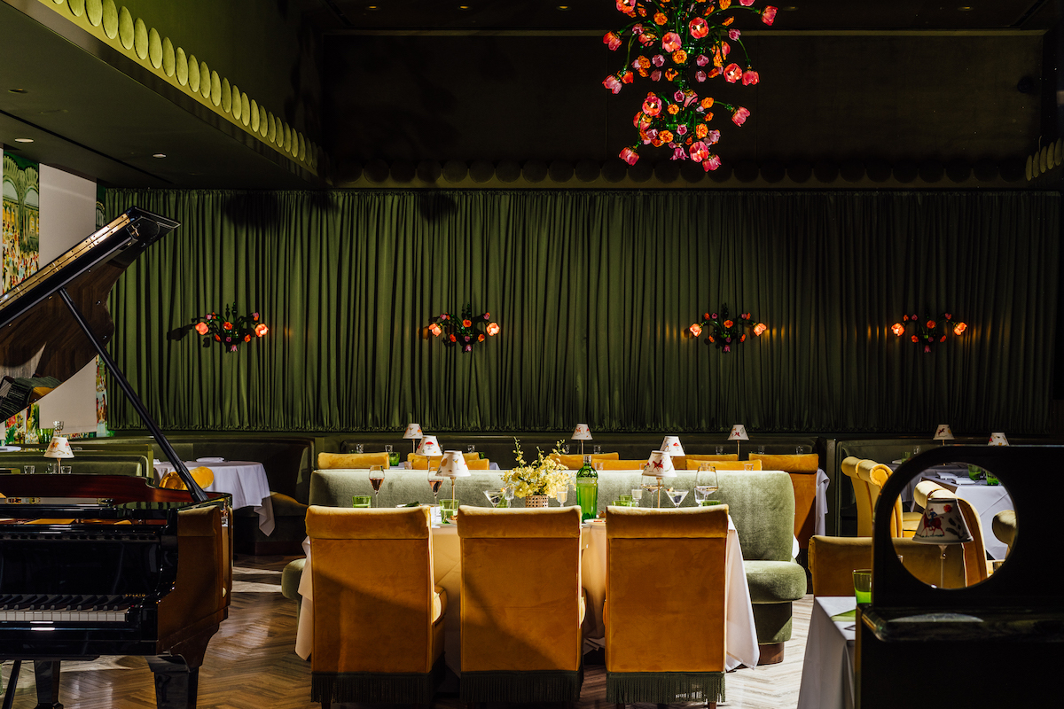 An elegant Steinway piano is a fixture in the Marigold Club's moody dining room. | Photo by Arturo Olmos