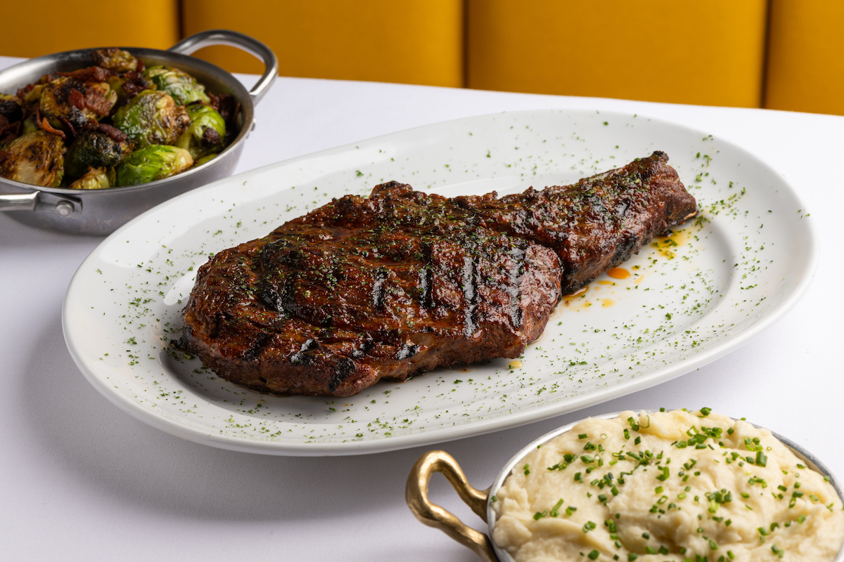 Ribeye with sides at Steak 48. | Photo by Prime Steak Concepts