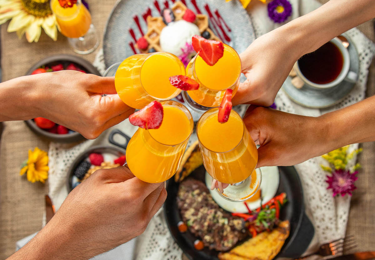 Mimosa cheers over a brunch spread at Toca Madera. | Photo by Max Milla