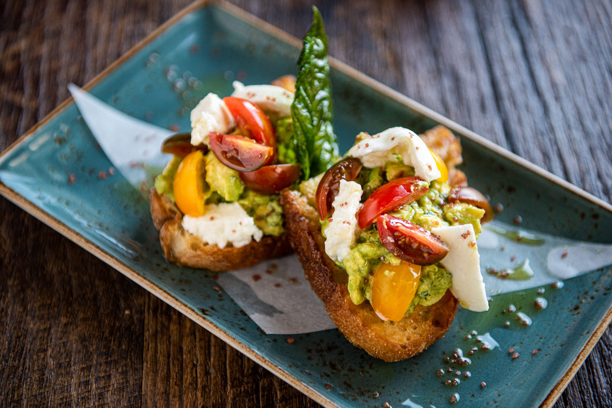 Avocado and burrata bruschetta at CRÚ Food & Wine Bar. | Photo by CRÚ Food & Wine Bar