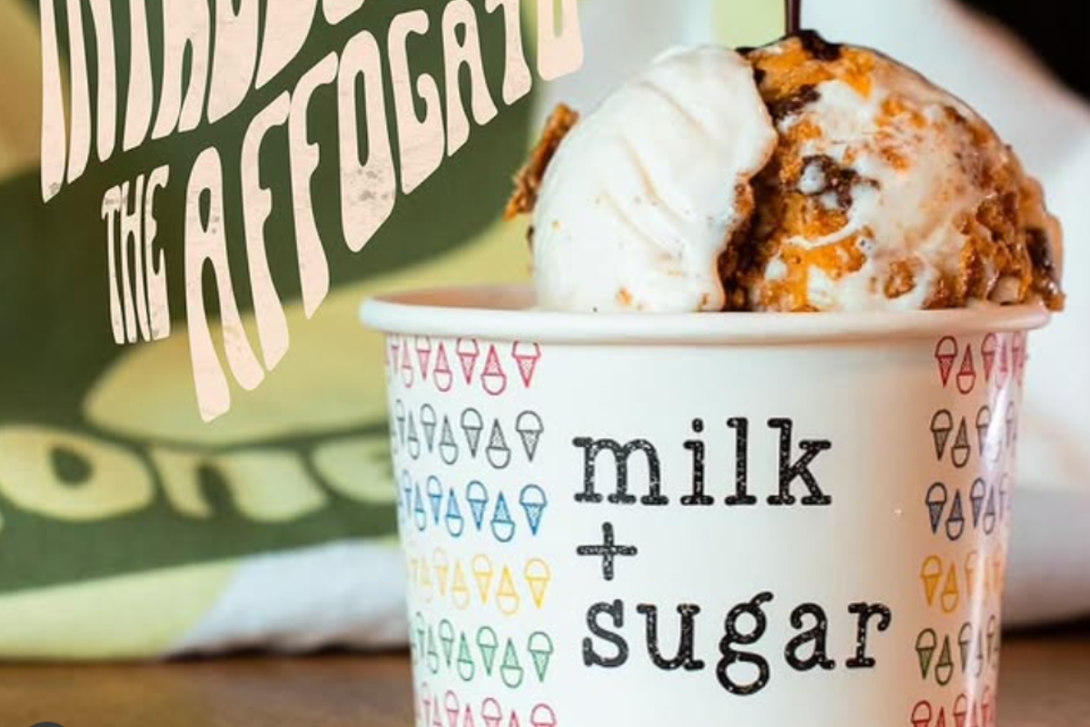 Cup of creamy Milk + Sugar affogato-inspired ice cream with crunchy mix-ins, served in a branded cup with colorful ice cream cone icons and bold text.