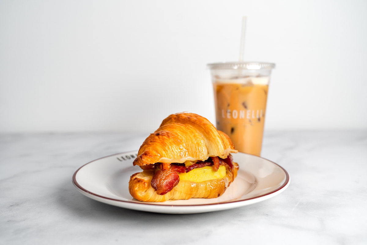 BaconEggCheese-EmilyChan-4 - DiningOut Houston Bacon, egg, and cheese croissant sandwich with ice coffee at Cafe Leonelli. | Photo by Emily Chan