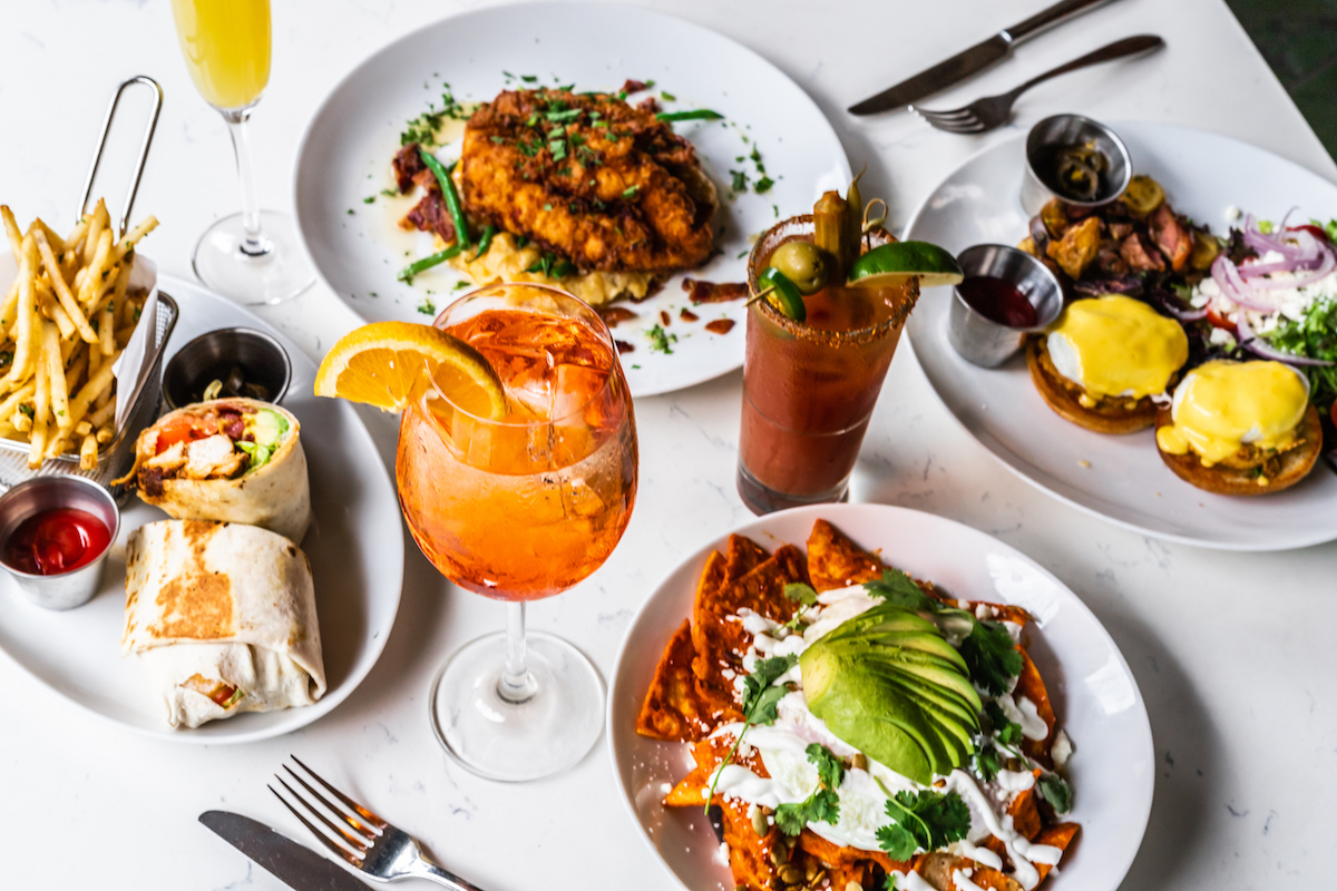 Hero Food Image Horizontal 2 - DiningOut Houston A spread of dishes and cocktails at Monarch at Hotel ZaZa. | Photo by Hotel ZaZa