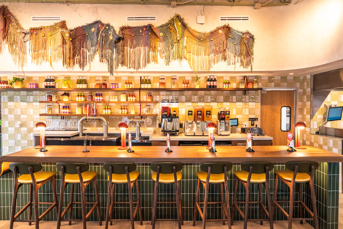 A large-scale textural installation commissioned exclusively for Nando's Montrose hangs above the bar. | Photo by Michael Anthony