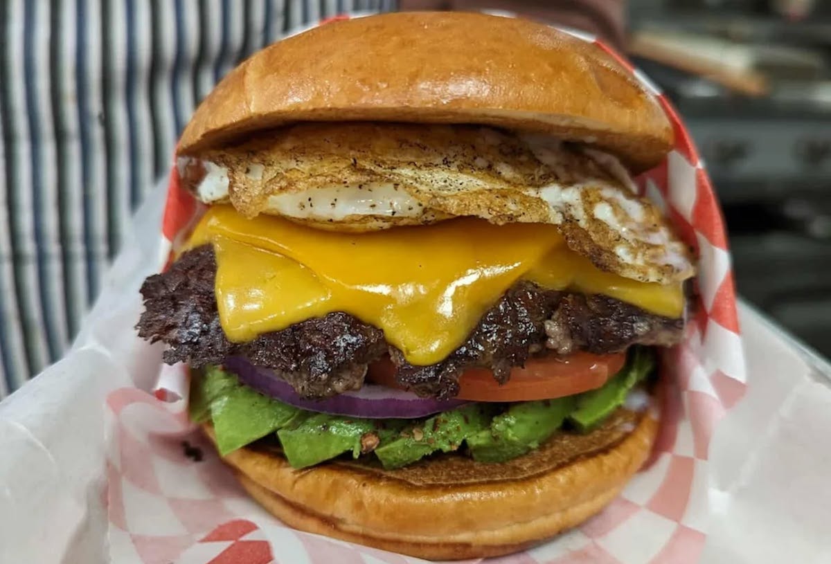 burger-chan - DiningOut Houston A beef burger layered with cheese and toppings at burger-chan. | Photo by burger-chan