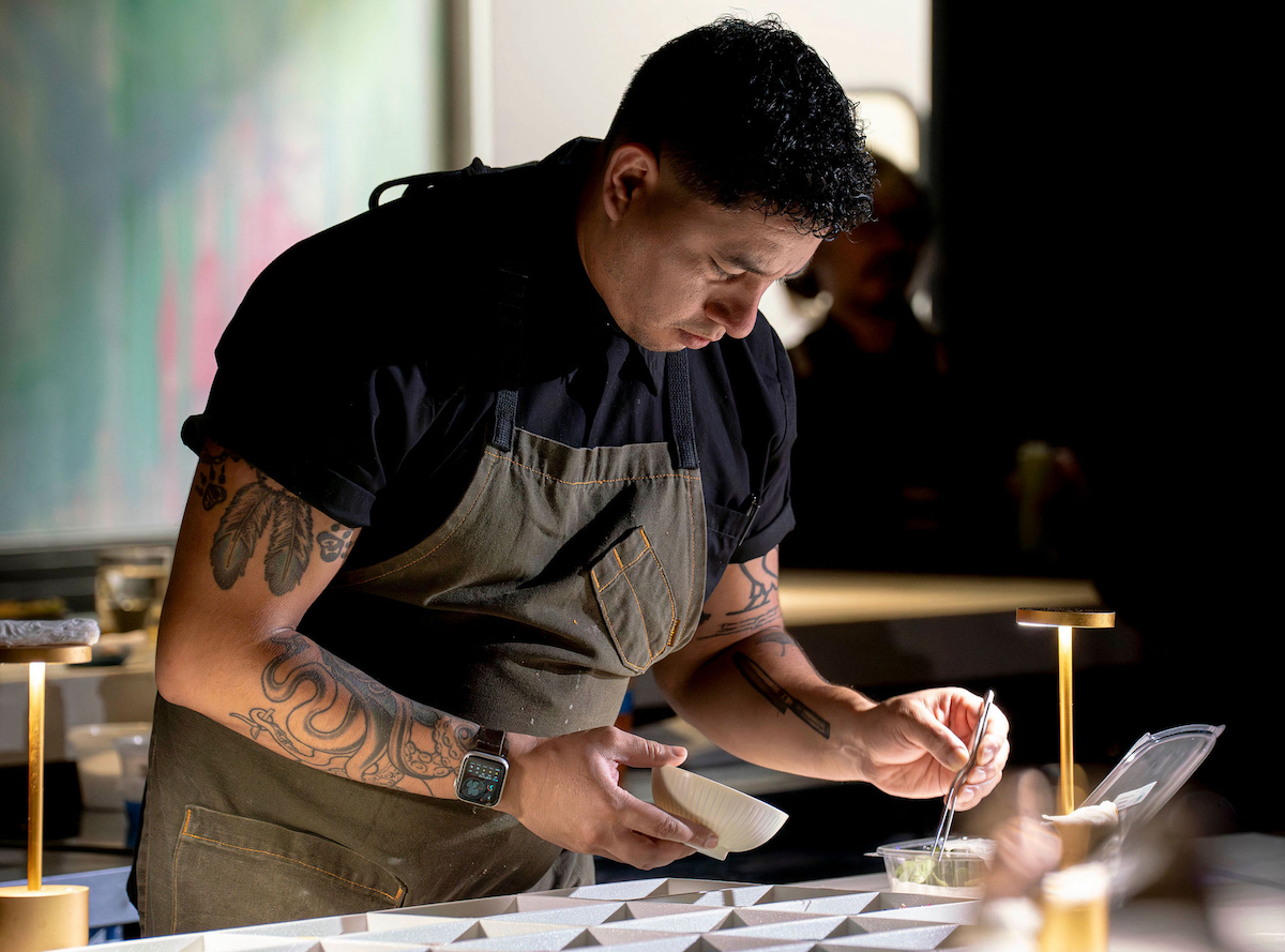 Chef Marcos Juarez plating behind the counter at Hidden Omakase. | Photo by Abante Photography