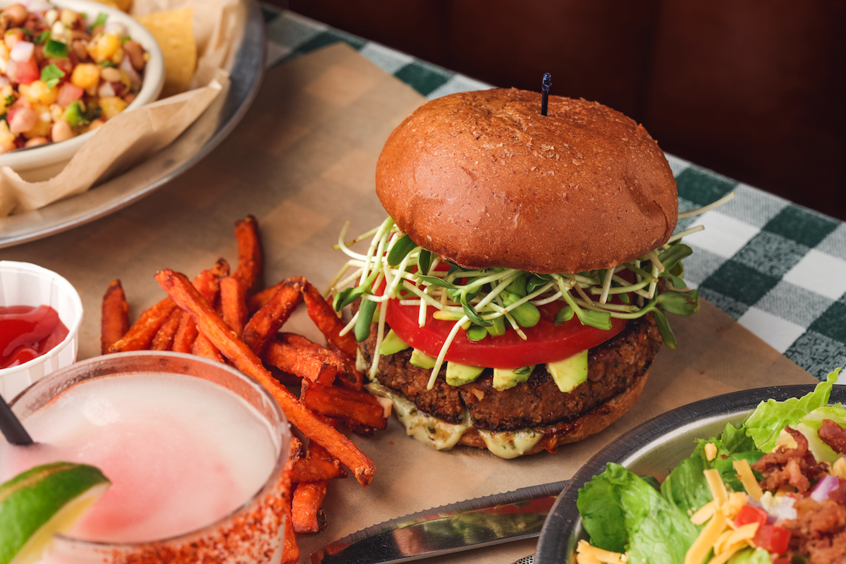 The Neil Young burger at Rodeo Goat, a meatless burger wth a vegan patty, sprouts, tomato, avocado, and green goddess dressing. | Photo by Allison David