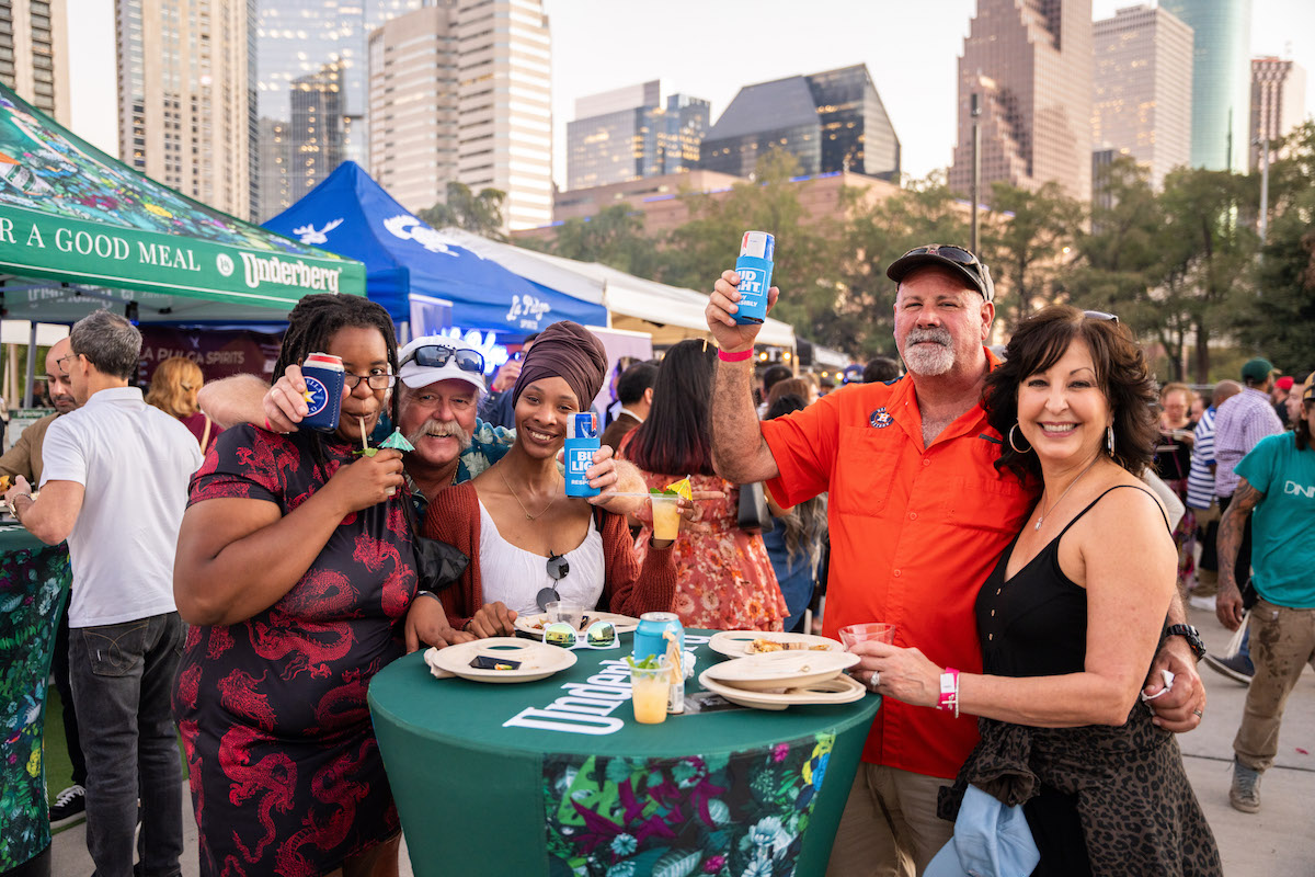 Attendees pose at RARE with Downtown Houston as a backdrop. | Photo by DiningOut