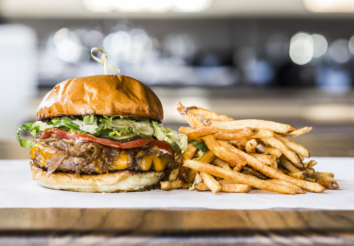 The classic burger at Relish, made with house-ground beef, cheddar, caramelized onions, aioli, pickles, lettuce, tomato, and served with hand-cut fries. | Photo by Julie Soefer