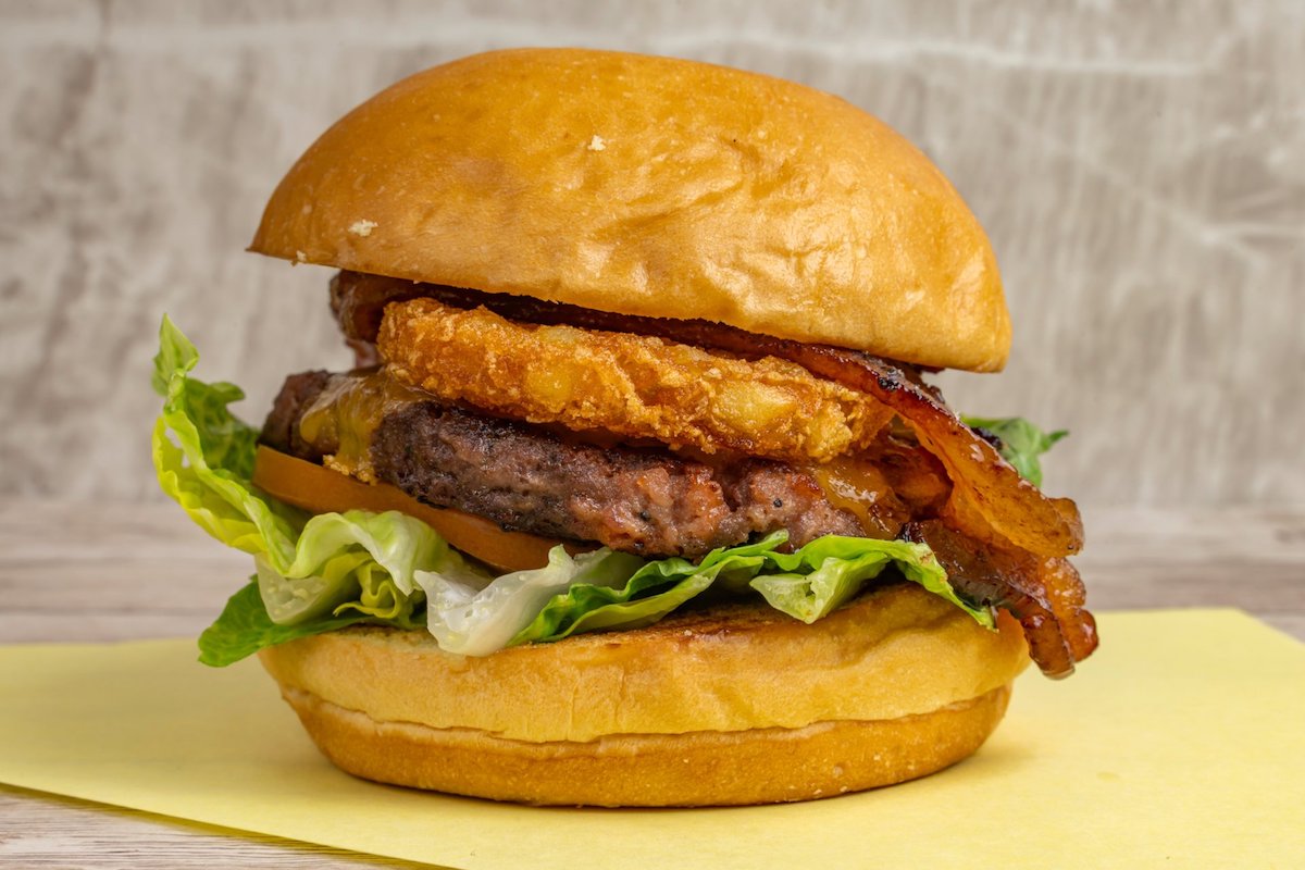 The Miss Piggie, at Stanton's City Bites, a combination of ground bacon and beef, topped with candied bacon, hash brown, cheddar, lettuce and tomatoes. | Photo by Stanton's City Bites